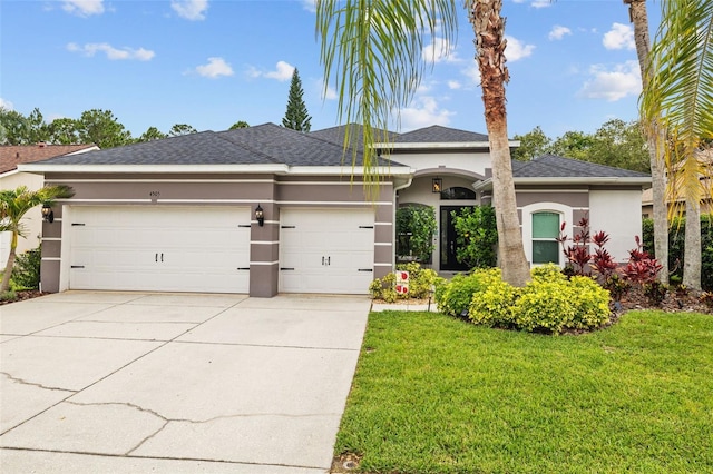 4505 Anaconda Dr, New Port Richey, FL 34655 - view of front of home with stucco siding, driveway, an attached garage, and a front lawn