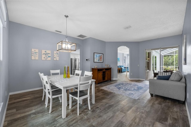 4505 Anaconda Dr, New Port Richey, FL 34655 - dining space featuring wood finished floors, baseboards, arched walkways, and a chandelier