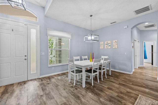 4505 Anaconda Dr, New Port Richey, FL 34655 - dining room with arched walkways, wood finished floors, and baseboards