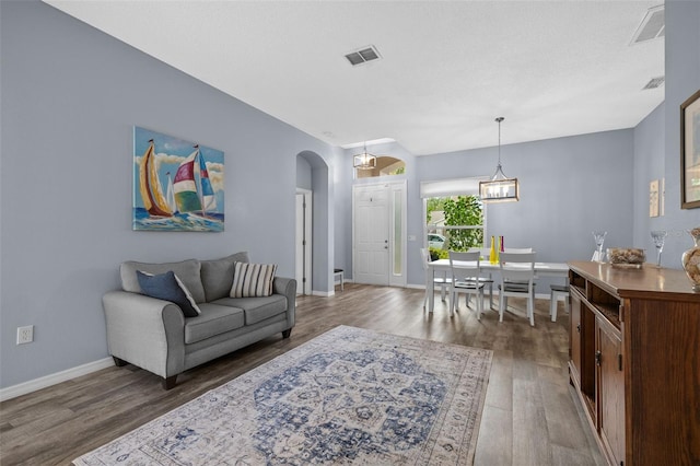 4505 Anaconda Dr, New Port Richey, FL 34655 - living area with wood finished floors, arched walkways, and baseboards
