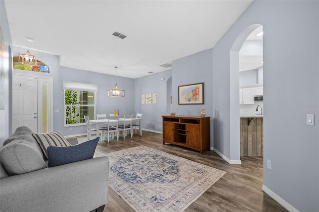 4505 Anaconda Dr, New Port Richey, FL 34655 - living area with dark wood-type flooring, baseboards, and arched walkways