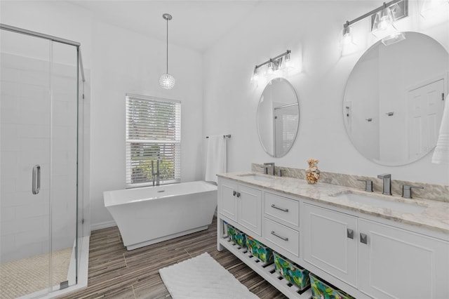 4505 Anaconda Dr, New Port Richey, FL 34655 - full bath with a shower stall, double vanity, a soaking tub, and wood finished floors