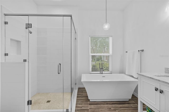 4505 Anaconda Dr, New Port Richey, FL 34655 - bathroom featuring a freestanding bath, a stall shower, vanity, and wood finished floors