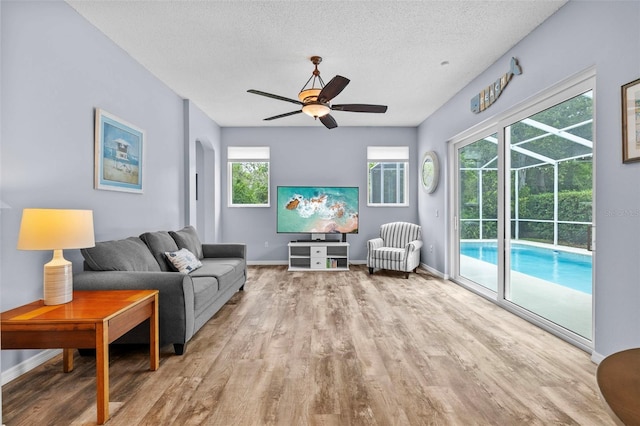 4505 Anaconda Dr, New Port Richey, FL 34655 - living room with wood finished floors, ceiling fan, baseboards, and a textured ceiling