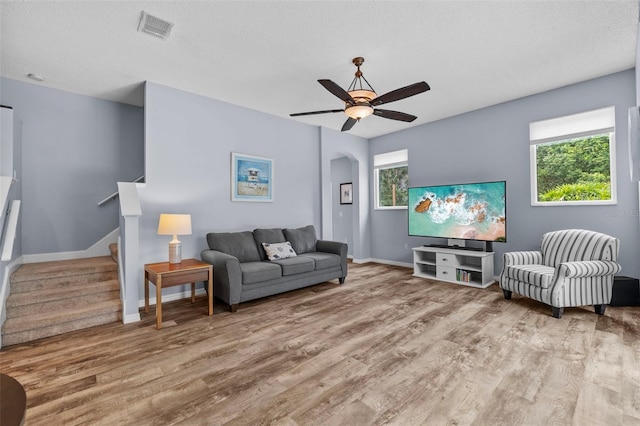 4505 Anaconda Dr, New Port Richey, FL 34655 - living room featuring wood finished floors, a ceiling fan, and stairway