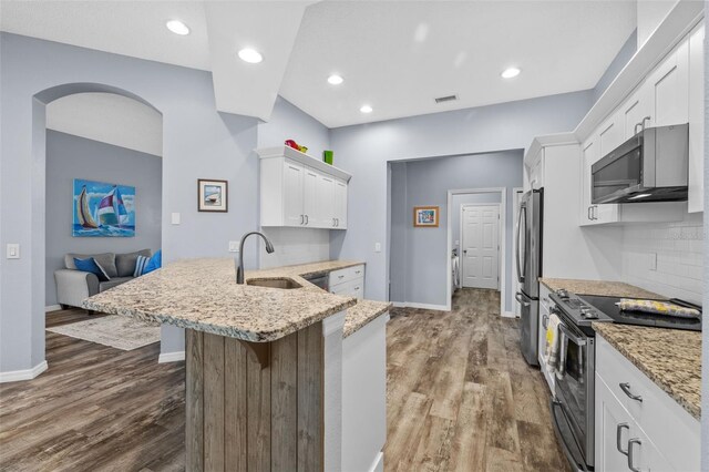 4505 Anaconda Dr, New Port Richey, FL 34655 - kitchen with appliances with stainless steel finishes, a sink, white cabinets, dark wood finished floors, and recessed lighting