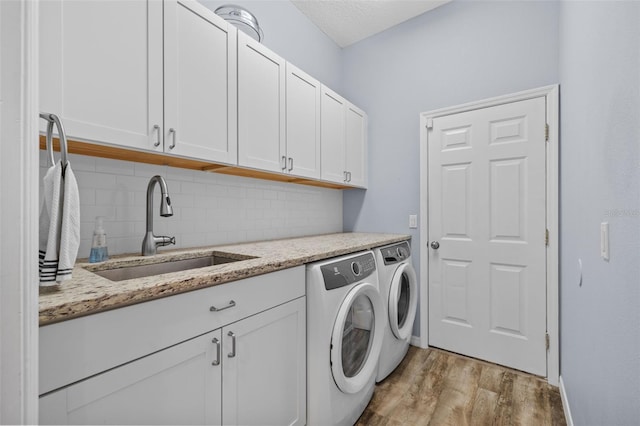 4505 Anaconda Dr, New Port Richey, FL 34655 - washroom featuring washer and dryer, cabinet space, light wood finished floors, and baseboards