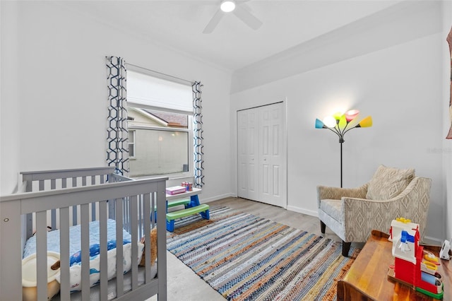 4505 Anaconda Dr, New Port Richey, FL 34655 - bedroom with a closet, baseboards, wood finished floors, a nursery area, and a ceiling fan