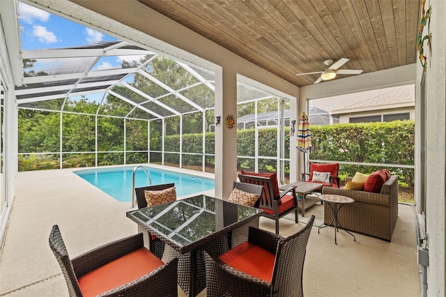 4505 Anaconda Dr, New Port Richey, FL 34655 - swimming pool featuring an outdoor hangout area, a patio, ceiling fan, and glass enclosure