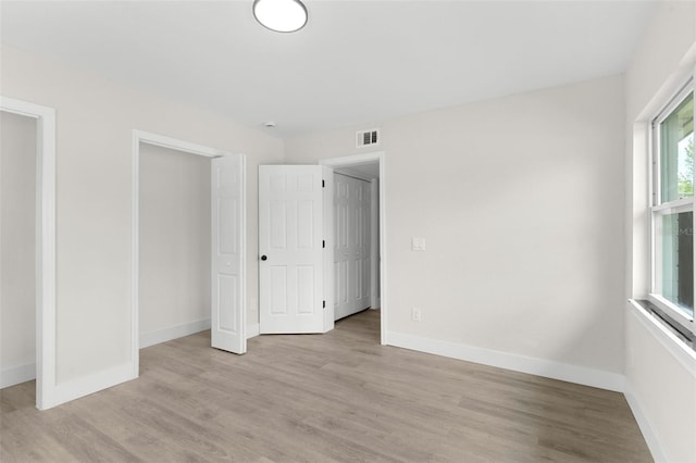837 E Edgewood Dr, Lakeland, FL 33803 - unfurnished bedroom featuring light wood-style flooring and baseboards