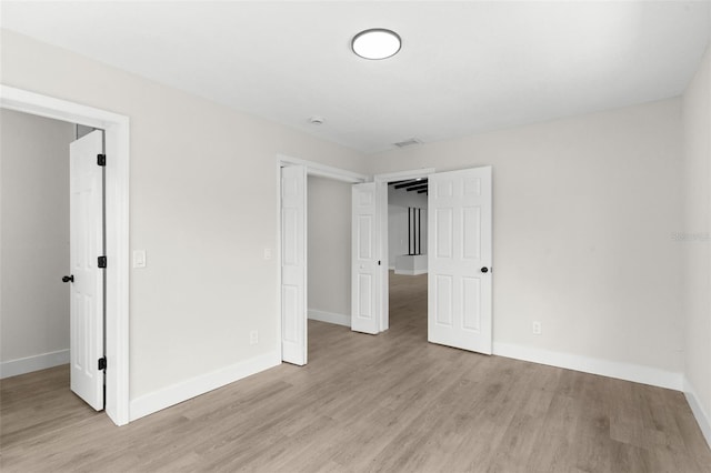 837 E Edgewood Dr, Lakeland, FL 33803 - unfurnished bedroom featuring light wood finished floors and baseboards