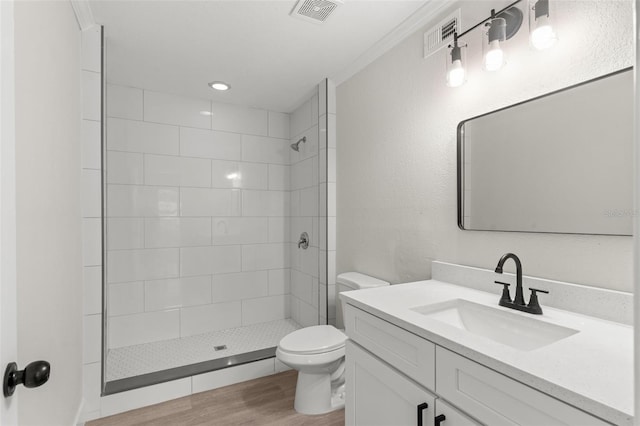 837 E Edgewood Dr, Lakeland, FL 33803 - bathroom with vanity, wood finished floors, toilet, and tiled shower