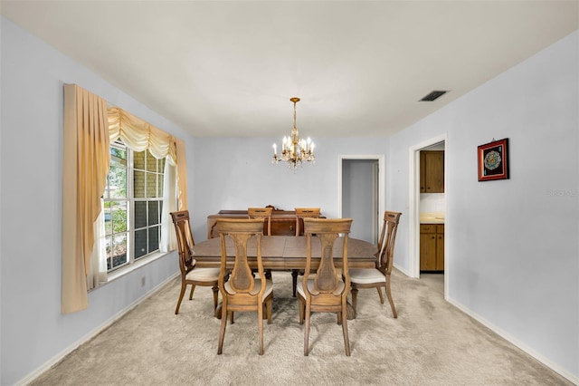 321 Belle View Ave, Temple Terrace, FL 33617 - dining room with a chandelier, baseboards, and light carpet