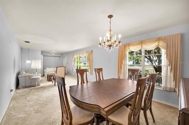 321 Belle View Ave, Temple Terrace, FL 33617 - dining room with light carpet, a chandelier, and baseboards