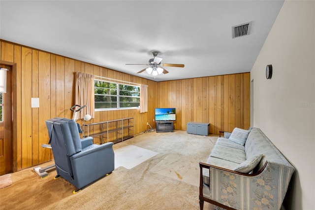 321 Belle View Ave, Temple Terrace, FL 33617 - carpeted living room featuring a ceiling fan and wood walls