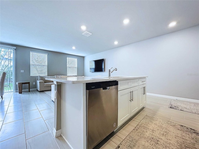 32451 Limitless Pl, Wesley Chapel, FL 33545 - kitchen featuring stainless steel dishwasher, open floor plan, a sink, white cabinets, and light countertops