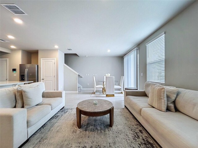 32451 Limitless Pl, Wesley Chapel, FL 33545 - living area with stairway, recessed lighting, baseboards, and wood finished floors