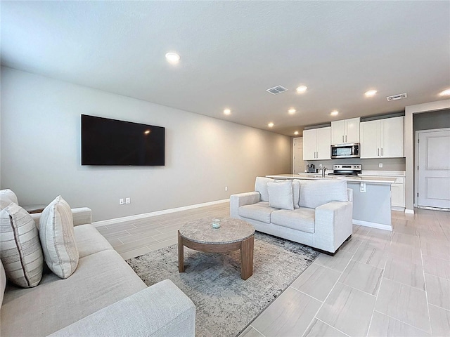 32451 Limitless Pl, Wesley Chapel, FL 33545 - living room with recessed lighting and baseboards