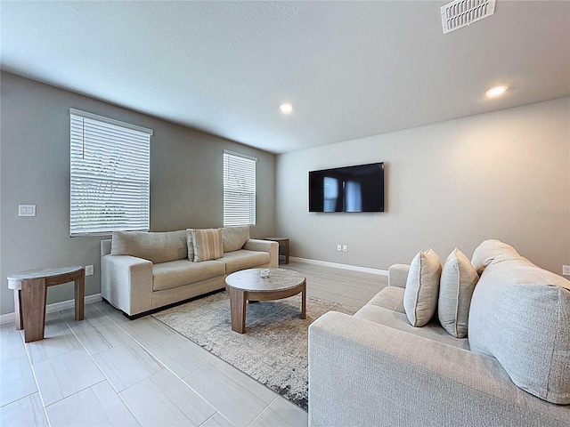 32451 Limitless Pl, Wesley Chapel, FL 33545 - living room featuring baseboards and recessed lighting