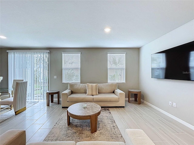 32451 Limitless Pl, Wesley Chapel, FL 33545 - living area featuring healthy amount of natural light, baseboards, recessed lighting, and wood tiled floors