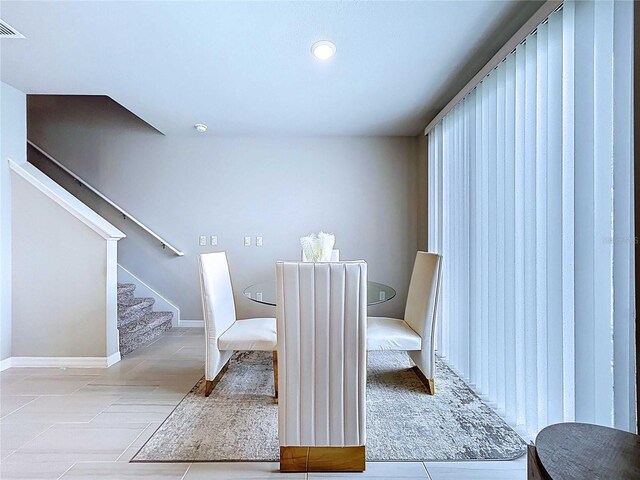 32451 Limitless Pl, Wesley Chapel, FL 33545 - dining space featuring stairs, tile patterned floors, baseboards, and recessed lighting