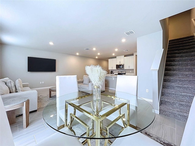 32451 Limitless Pl, Wesley Chapel, FL 33545 - living area featuring recessed lighting, stairs, and baseboards