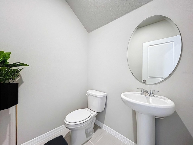 32451 Limitless Pl, Wesley Chapel, FL 33545 - half bath with toilet, baseboards, and vaulted ceiling