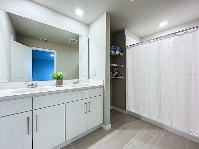 32451 Limitless Pl, Wesley Chapel, FL 33545 - full bathroom with double vanity, a shower with shower curtain, and recessed lighting