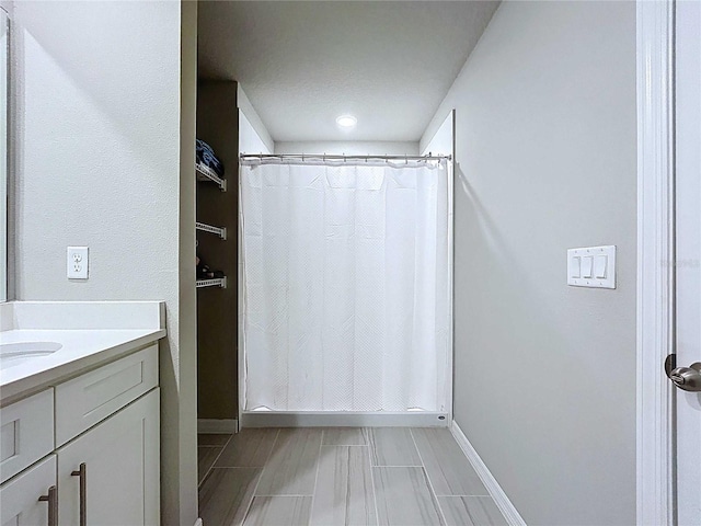 32451 Limitless Pl, Wesley Chapel, FL 33545 - bathroom featuring vanity, baseboards, and curtained shower
