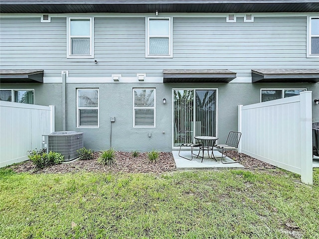 32451 Limitless Pl, Wesley Chapel, FL 33545 - back of property with central AC, stucco siding, and a patio area