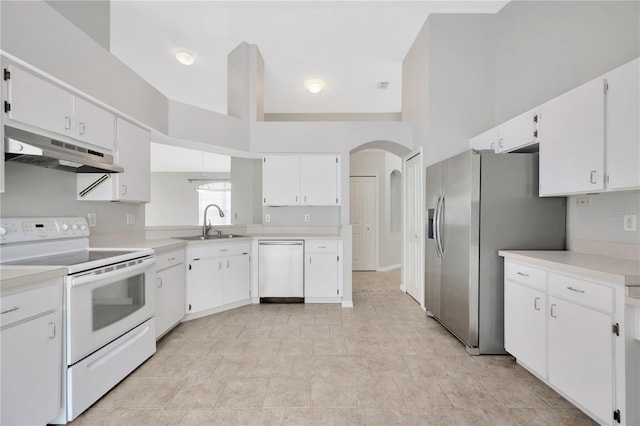 25101 Hyde Park Blvd, Land O Lakes, FL 34639 - kitchen featuring appliances with stainless steel finishes, under cabinet range hood, a sink, light countertops, and arched walkways