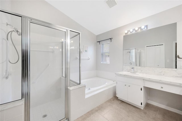 25101 Hyde Park Blvd, Land O Lakes, FL 34639 - bathroom featuring vaulted ceiling, vanity, a garden tub, a stall shower, and tile patterned flooring