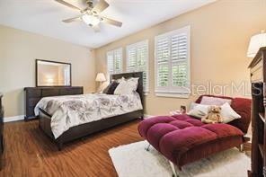 3104 W Fielder St, Tampa, FL 33611 - bedroom with baseboards, wood finished floors, and ceiling fan