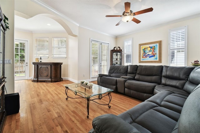 3104 W Fielder St, Tampa, FL 33611 - living area with arched walkways, ornamental molding, light wood-style floors, and plenty of natural light