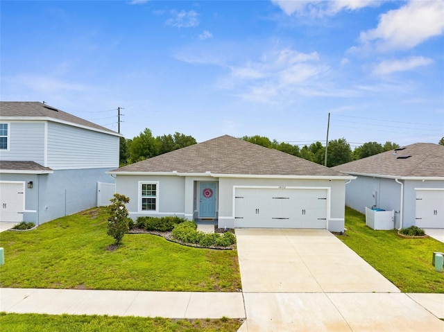 14532 Whitewater Way, Brooksville, FL 34604 - ranch-style home with a front lawn, stucco siding, a shingled roof, and driveway