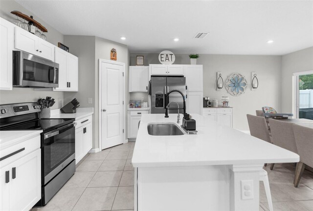 14532 Whitewater Way, Brooksville, FL 34604 - kitchen featuring appliances with stainless steel finishes, a sink, light tile patterned floors, light countertops, and recessed lighting