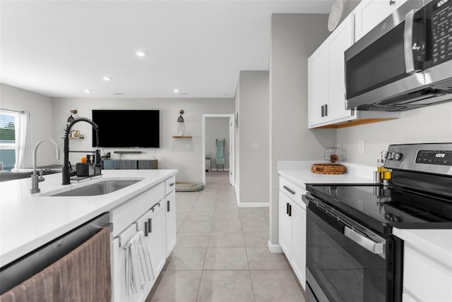 14532 Whitewater Way, Brooksville, FL 34604 - kitchen with appliances with stainless steel finishes, a sink, light countertops, recessed lighting, and light tile patterned flooring