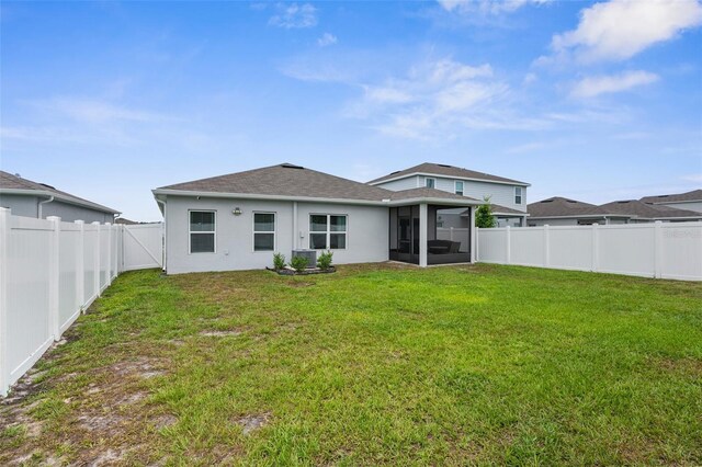 14532 Whitewater Way, Brooksville, FL 34604 - rear view of property featuring a sunroom, stucco siding, and a shingled roof