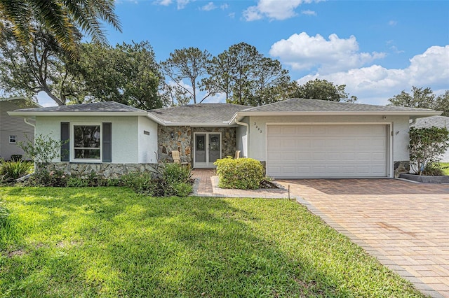 2222 Westchester Blvd, Spring Hill, FL 34606 - ranch-style house with stucco siding, stone siding, and a garage