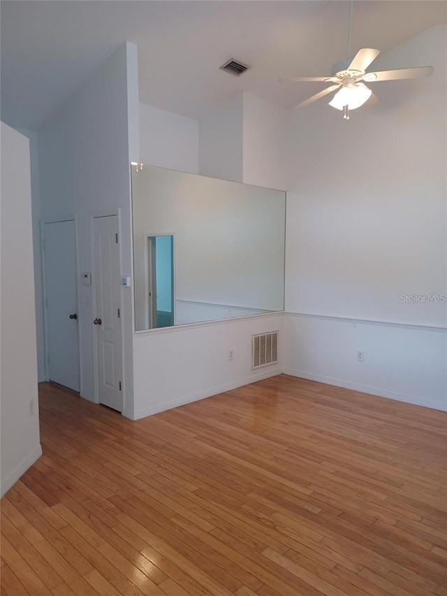 1605 Send Way, Lutz, FL 33549 - empty room with light wood-style flooring, ceiling fan, and high vaulted ceiling