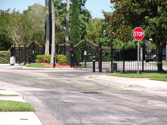 1605 Send Way, Lutz, FL 33549 - view of asphalt street featuring traffic signs and a gate