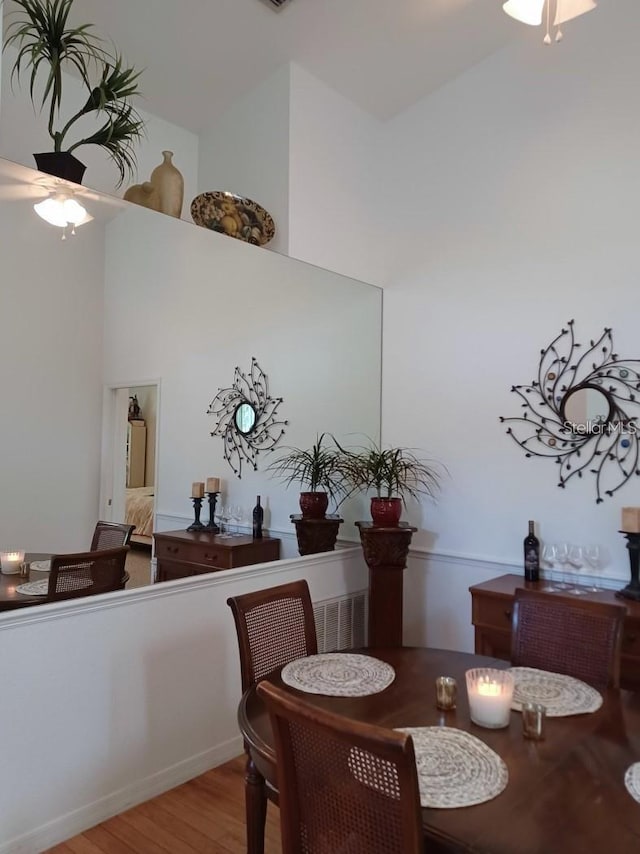 1605 Send Way, Lutz, FL 33549 - dining space featuring a ceiling fan, wood finished floors, and a high ceiling