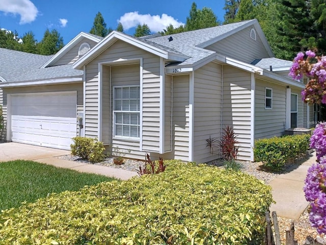 1605 Send Way, Lutz, FL 33549 - ranch-style house with a shingled roof, a garage, and driveway