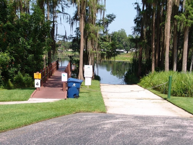 1605 Send Way, Lutz, FL 33549 - dock area with a boat ramp, a water view, and a lawn