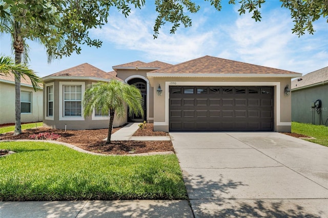 13910 Chalk Hill Pl, Riverview, FL 33579 - view of front of house featuring stucco siding, concrete driveway, an attached garage, a front lawn, and a shingled roof