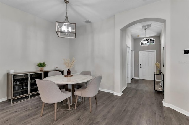 13910 Chalk Hill Pl, Riverview, FL 33579 - dining room with a chandelier, arched walkways, dark wood-type flooring, and baseboards