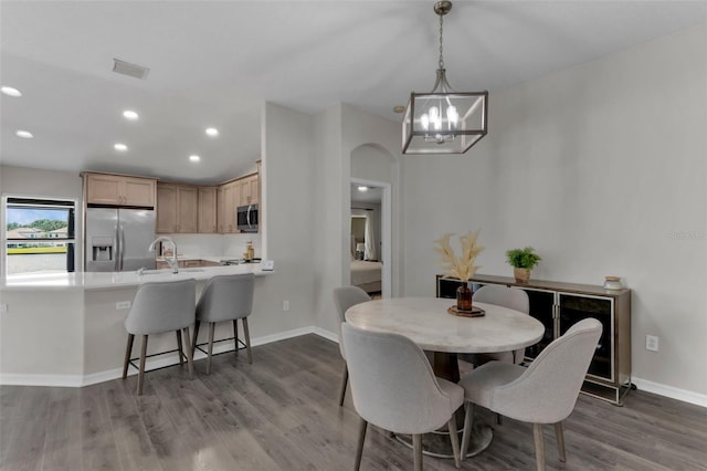 13910 Chalk Hill Pl, Riverview, FL 33579 - dining room with a chandelier, dark wood finished floors, baseboards, recessed lighting, and arched walkways