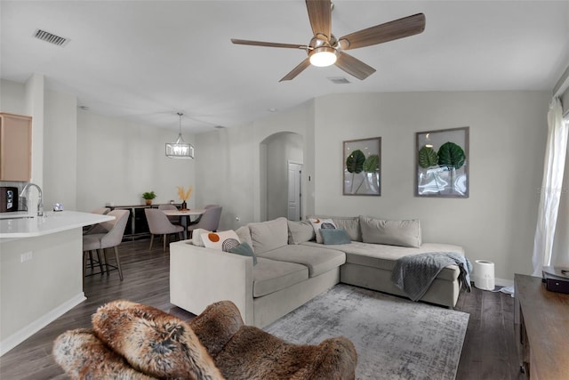 13910 Chalk Hill Pl, Riverview, FL 33579 - living room with arched walkways, ceiling fan, dark wood-type flooring, and baseboards