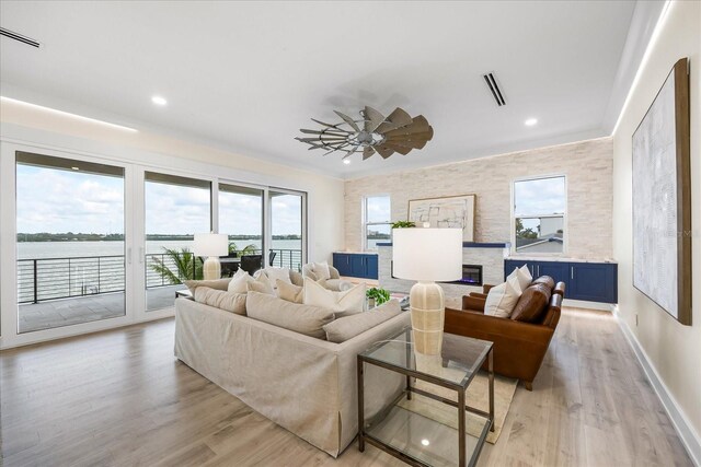 820 Bay Point Dr, Madeira Beach, FL 33708 - living area featuring light wood-type flooring, recessed lighting, a ceiling fan, baseboards, and a water view
