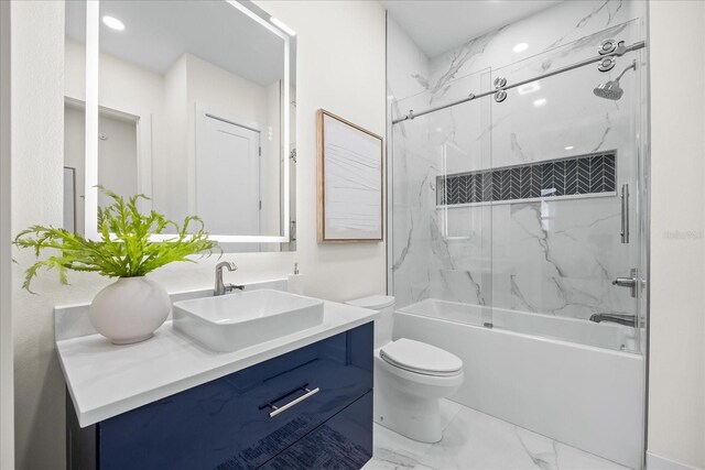 820 Bay Point Dr, Madeira Beach, FL 33708 - full bathroom featuring vanity, marble finish flooring, shower / bathtub combination, and toilet